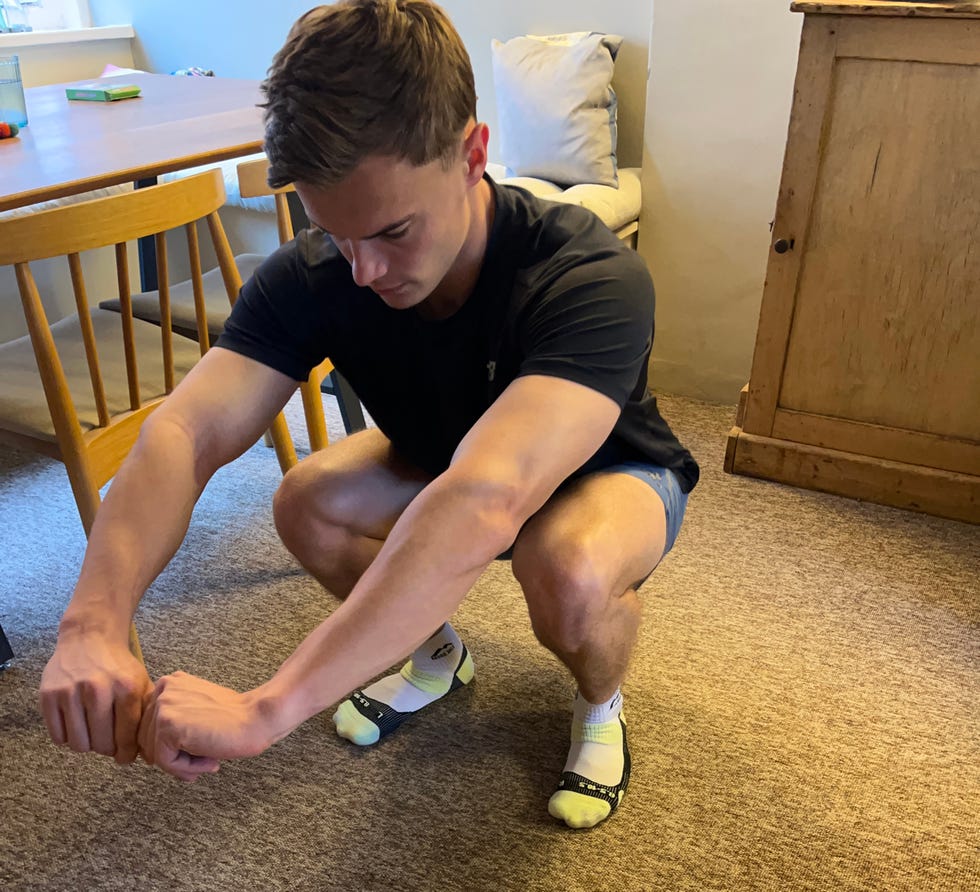 person performing a squat exercise indoors