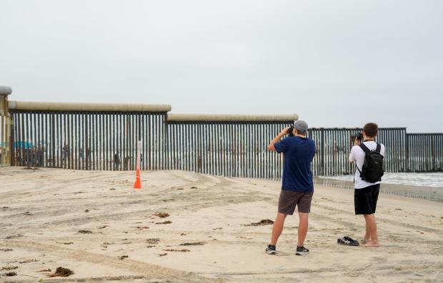 Border Field State Park and Friendship Park are open to the public. Joshua McNeil 27, with his brother Lucas Bowen 15, visiting from out of state. Taking photos at Border Field State Park Beach on Sunday, Aug. 24, 2025 in San Diego, California. (Alejandro Tamayo / The San Diego Union-Tribune)