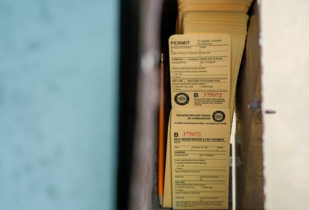 Vehicles are permitted Saturday and Sunday for $5 day use parking fee. Drivers pay the money in self registration envelopes at the main entrance at Border Field State Park. (Alejandro Tamayo / The San Diego Union-Tribune)