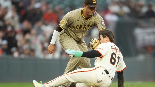 The Giants' Drew Gilbert is tagged out by Padres third baseman Manny Machado in the the third inning Monday. (AP Photo/Jeff Chiu)