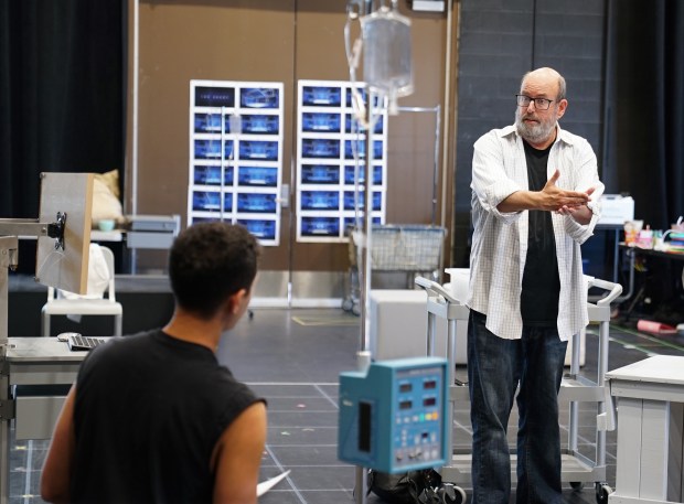 La Jolla Playhouse Artistic Director Christopher Ashley (right) speaks with cast member Lincoln Clauss during a rehearsal for the world-premiere musical "The Heart." (Samantha Laurent)