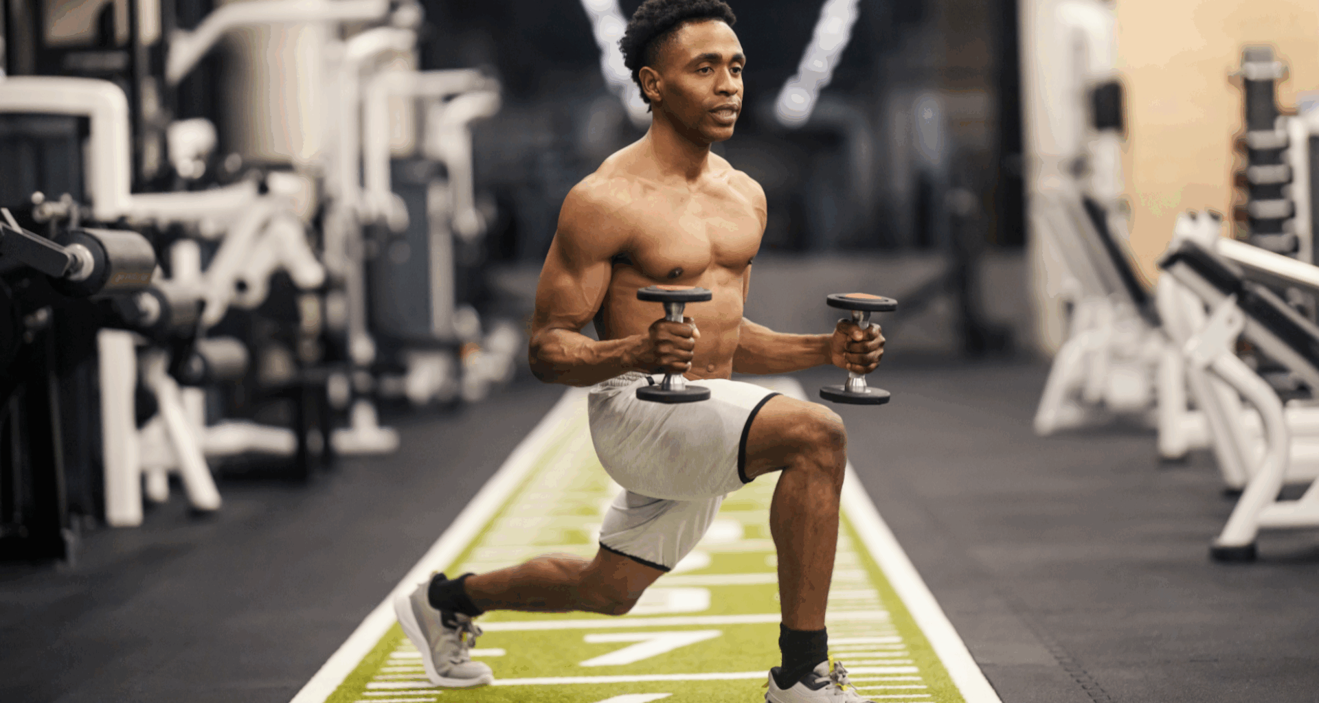 A man doing a lunge with two light dumbbells