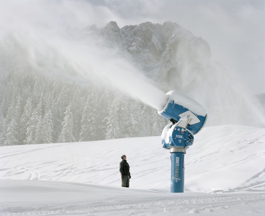 Snow cannon producing artificial snow at Dolomites ski resort. Italy
