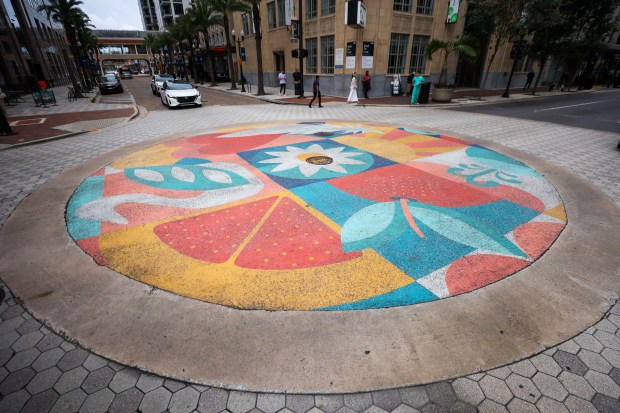 The mural painted on the street at the intersection of...