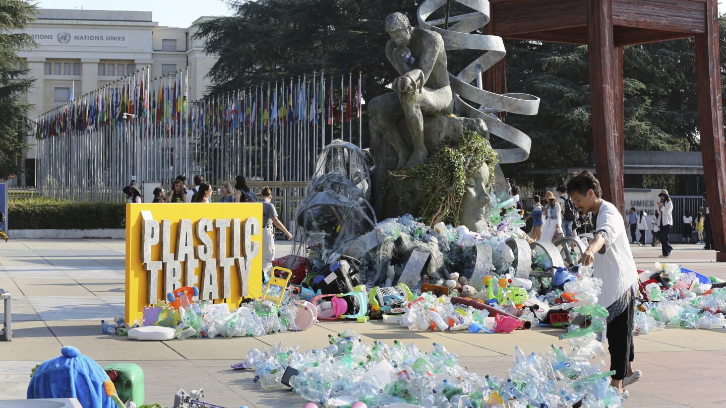 Artist drowns sculpture in plastic waste in front of the UN during plastic pollution treaty talks
