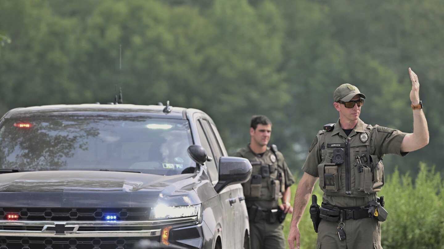 Woman killed by neighbor before responding state troopers were ambushed by gunfire, police say