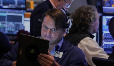 Stocks hold steady just below recent records on Wall Street