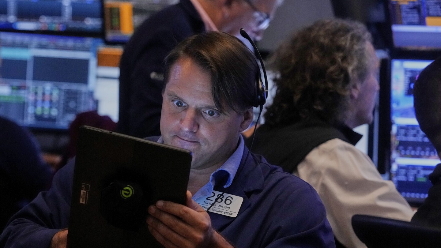 Stocks hold steady just below recent records on Wall Street