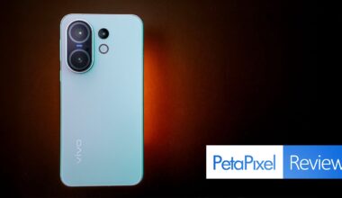 A light blue Vivo smartphone with dual rear cameras is displayed on a dark brown background. The phone is centered above the Petapixel Reviews logo in the bottom right corner.