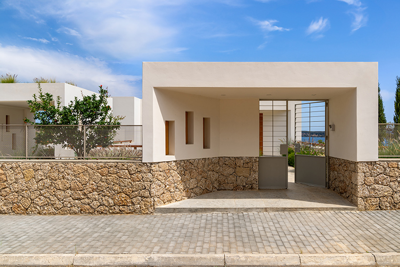 pieris.architects embeds layered stone-and-plaster residence into greek hillside