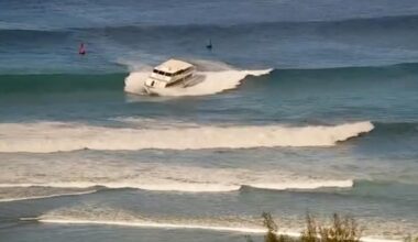 Yacht-sized passenger boat runs aground in high surf off Hawaii beach