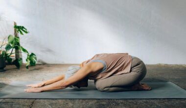 Woman lying on bed doing yoga against the wall