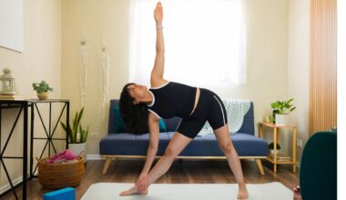 woman does triangle yoga pose at home