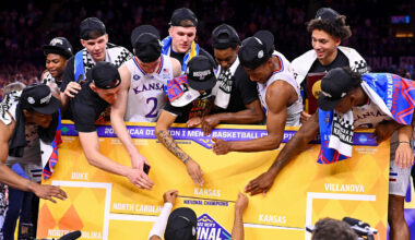 Apr 4, 2022; New Orleans, LA, USA; The Kansas Jayhawks place their name as national champions on the bracket after their win against the North Carolina Tar Heels in the 2022 NCAA men's basketball tournament Final Four championship game at Caesars Superdome. Mandatory Credit: Bob Donnan-Imagn Images