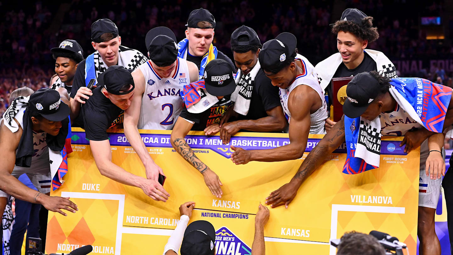 Apr 4, 2022; New Orleans, LA, USA; The Kansas Jayhawks place their name as national champions on the bracket after their win against the North Carolina Tar Heels in the 2022 NCAA men's basketball tournament Final Four championship game at Caesars Superdome. Mandatory Credit: Bob Donnan-Imagn Images