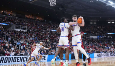 Mar 20, 2025; Providence, RI, USA;  Kansas Jayhawks center Hunter Dickinson (1) and forward Flory Bidunga (40) defend against Arkansas Razorbacks during the first half at Amica Mutual Pavilion. Mandatory Credit: Gregory Fisher-Imagn Images