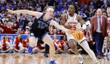 Mar 22, 2025; Denver, CO, USA; Wisconsin Badgers guard John Blackwell (25) dribbles the ball past Brigham Young Cougars forward Richie Saunders (15) during the first half in the second round of the NCAA Tournament  at Ball Arena. Mandatory Credit: Isaiah J. Downing-Imagn Images