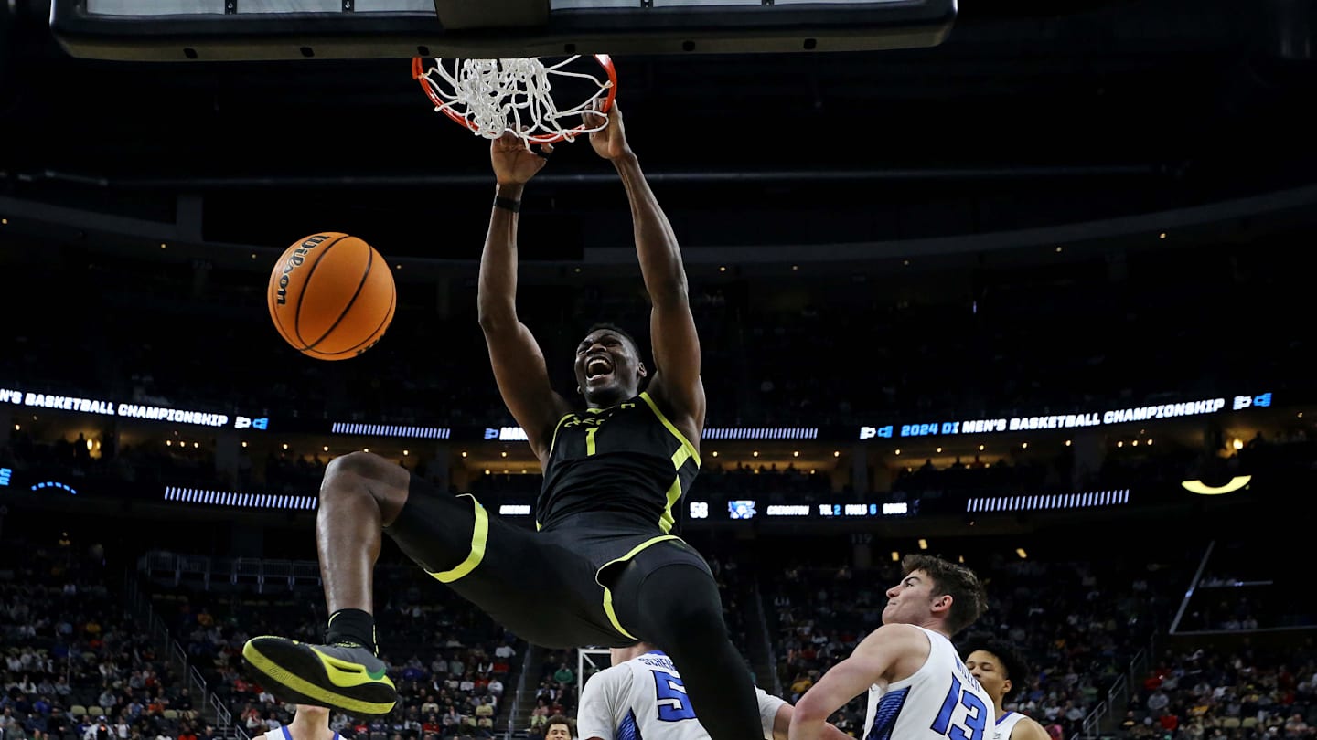 Mar 23, 2024; Pittsburgh, PA, USA; Oregon Ducks center N'Faly Dante (1) dunks the ball against Creighton Bluejays guard Baylor Scheierman (55) in the second round of the 2024 NCAA Tournament at PPG Paints Arena. Mandatory Credit: Charles LeClaire-Imagn Images