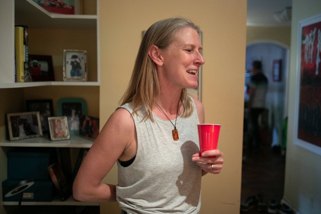 Amy Anthony smiles while speaking about volunteering at St. George's Church Common table.