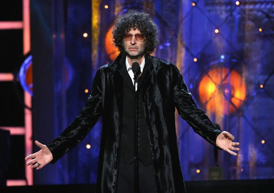 Howard Stern gestures onstage