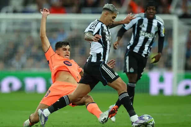 Gerard Martin of FC Barcelona challenges Bruno Guimaraes of Newcastle United