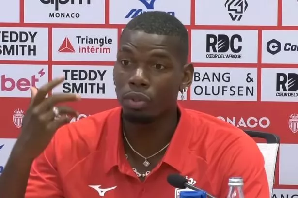 Paul Pogba wearing a Monaco shirt while speaking in a press conference