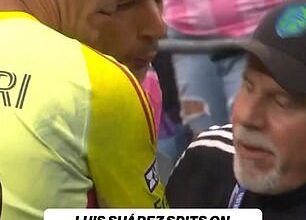 Luis Suarez appeared to spit on a rival coach