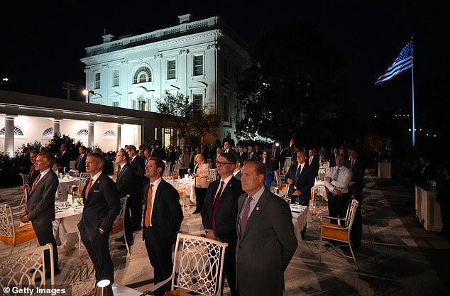 People stand at the White House during the swanky evening, hosted by the president