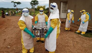 Healthcare workers carry a coffin with a baby, suspected of dying from Ebola, in the Democratic Republic of Congo during an outbreak in 2018