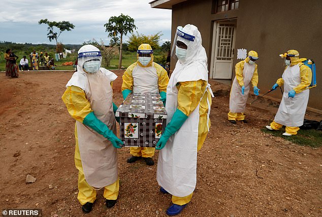 Healthcare workers carry a coffin with a baby, suspected of dying from Ebola, in the Democratic Republic of Congo during an outbreak in 2018