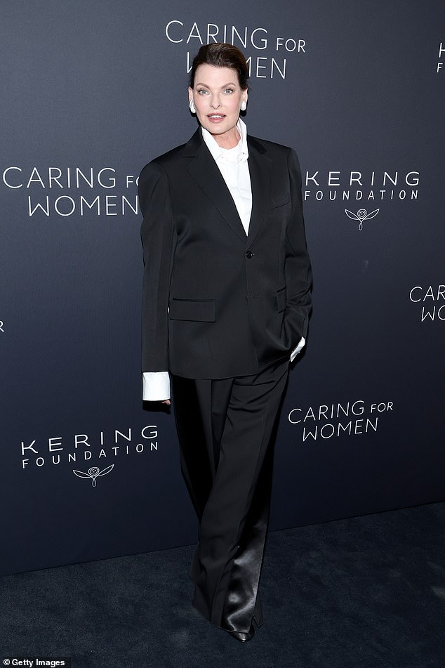 The supermodel additionally sported a white blouse underneath and slipped into a pair of closed-toed, black pumps
