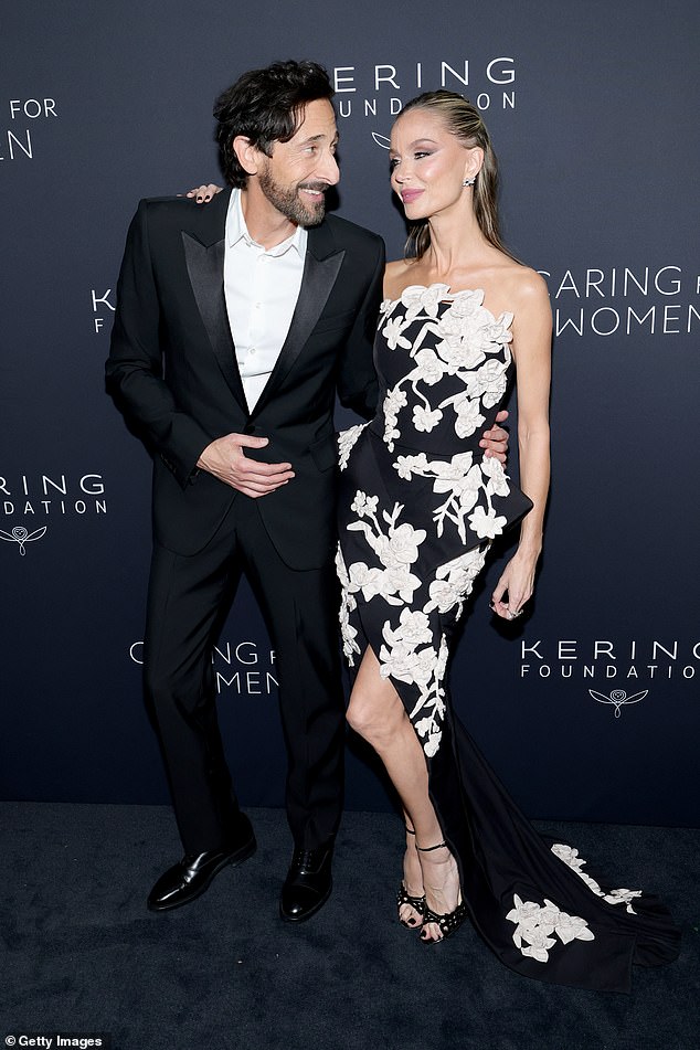 Clad in a black tuxedo without a bow tie, Adrien Brody looked smitten with girlfriend Georgina Chapman, who is the ex-wife of disgraced Hollywood producer Harvey Weinstein