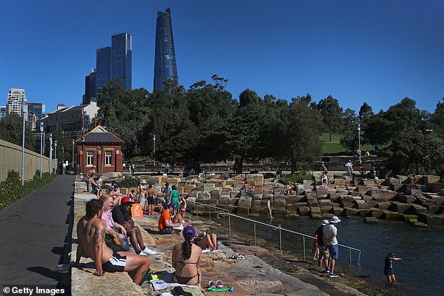 Locals have questioned the timing of the closure, with some asking why the work was not completed over winter (above, swimmers at the cove)