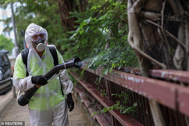 A worker sprays insecticide at a public housing estate following reports of imported cases of Chikungunya virus in Hong Kong in August