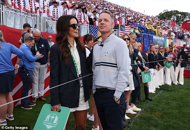 Luke Donald stands next to his wife, Diane, as they watch morning foursome action
