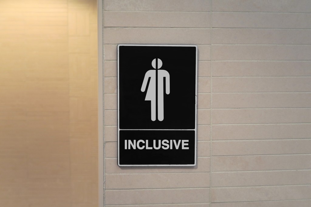 Gender-neutral restroom sign that says, "INCLUSIVE"
