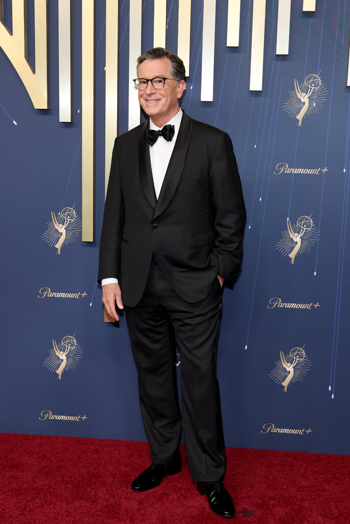 A man wears a black suit.