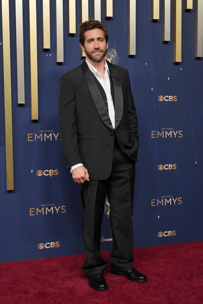 A man wears a black suit.
