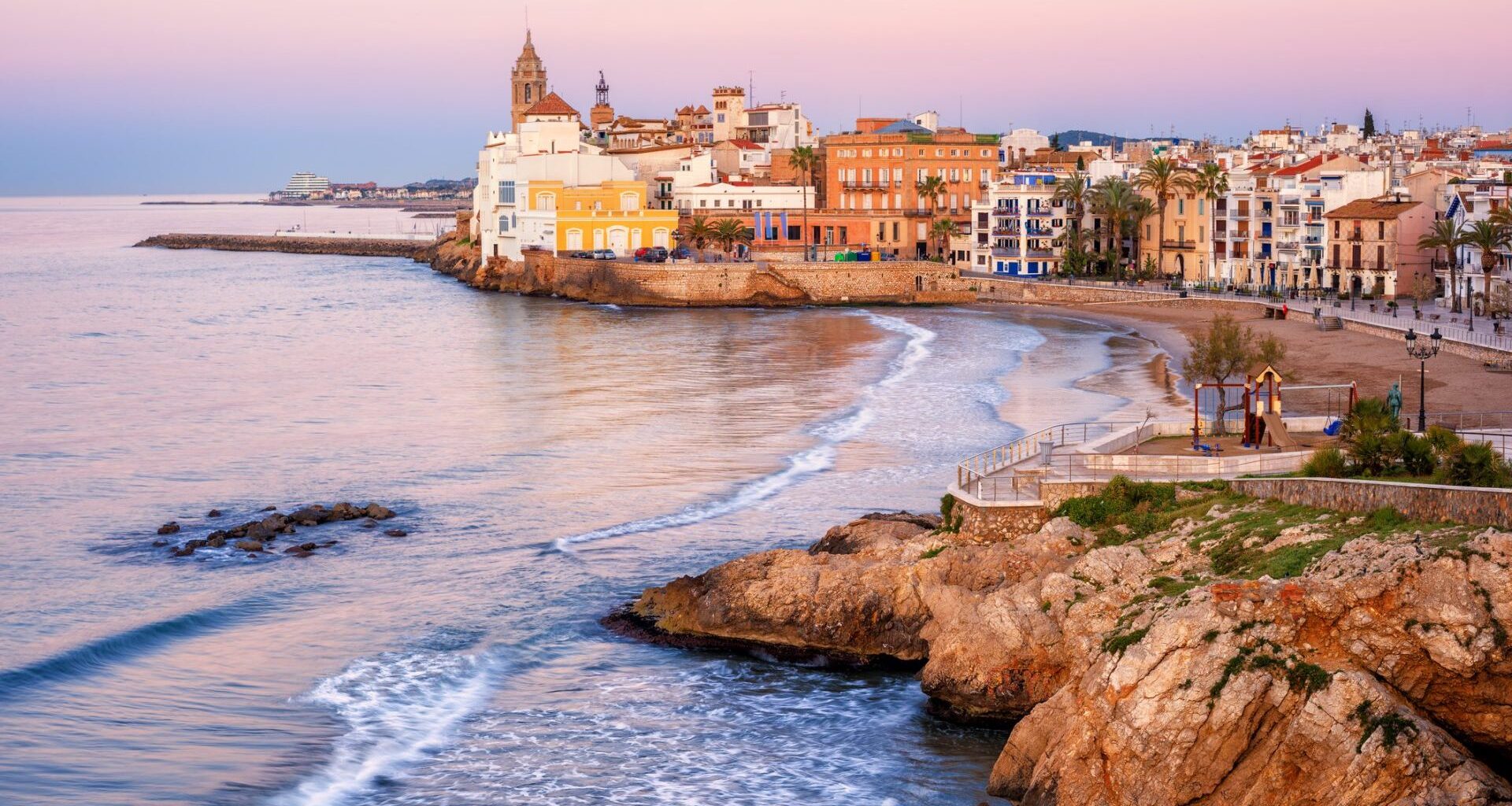 Sand beach and historical Old Town in mediterranean resort Sitges near Barcelona, Costa Dorada, Catalonia, Spain.