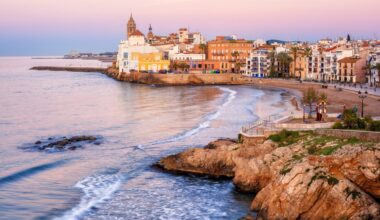 Sand beach and historical Old Town in mediterranean resort Sitges near Barcelona, Costa Dorada, Catalonia, Spain.