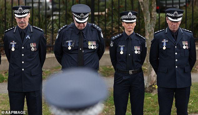 Police attendees pay their respects during a funeral procession following the funeral service for Detective Leading Senior Constable Neal Thompson at the Victoria Police Academy Chapel in Melbourne, Monday, September 8, 2025. (AAP Image/Con Chronis) NO ARCHIVING