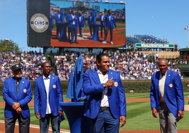 Chicago Cubs Hall of Famer Sammy Sosa puts his hand on his heart after receiving his blue jacket at Wrigley Field on Sept. 7, 2025, in Chicago. (Stacey Wescott/Chicago Tribune)