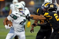 Waxahachie high RB Wade Lemons (2) is tackled by  Forney defender Nolan Williams (23) during...