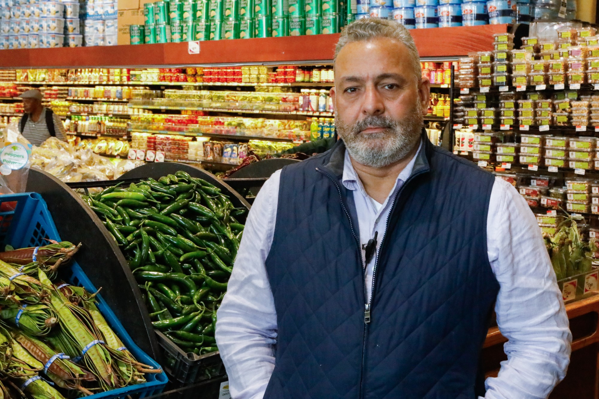 SuperFresh owner Frank Pimentel poses for a portrait next to the produce section.