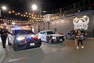 Dallas police vehicles are seen in front of Rodeo Dallas in Deep Ellum in August 2025. 