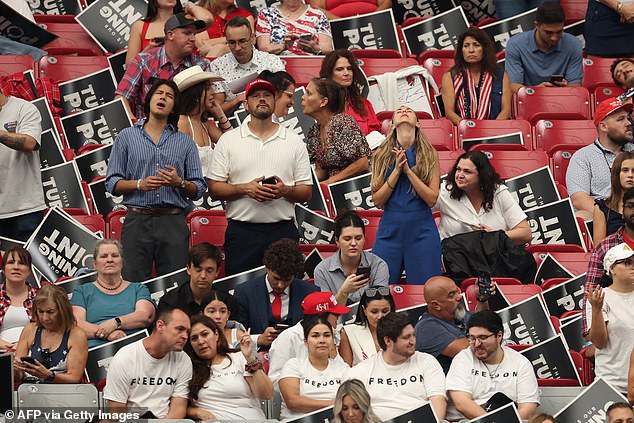 People pray ahead of the public memorial service for right-wing activist Charlie Kirk at State Farm Stadium in Glendale, Arizona, on September 21, 2025. (Photo by Patrick T. Fallon / AFP) (Photo by PATRICK T. FALLON/AFP via Getty Images)