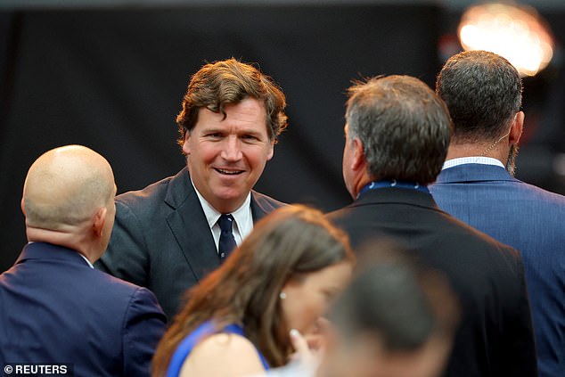 Political commentator Tucker Carlson arrives for a memorial service for slain conservative commentator Charlie Kirk at State Farm Stadium, on the day of a memorial service for slain conservative commentator Charlie Kirk, in Glendale, Arizona, U.S., September 21, 2025.  REUTERS/Carlos Barria