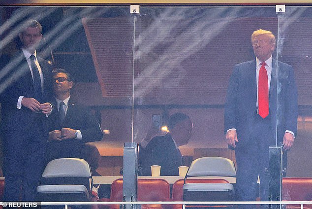 BRIGHTENED - U.S. President Donald Trump and his son Eric Trump arrive for a memorial service for slain conservative commentator Charlie Kirk at State Farm Stadium, in Glendale, Arizona, U.S., September 21, 2025.  REUTERS/Carlos Barria