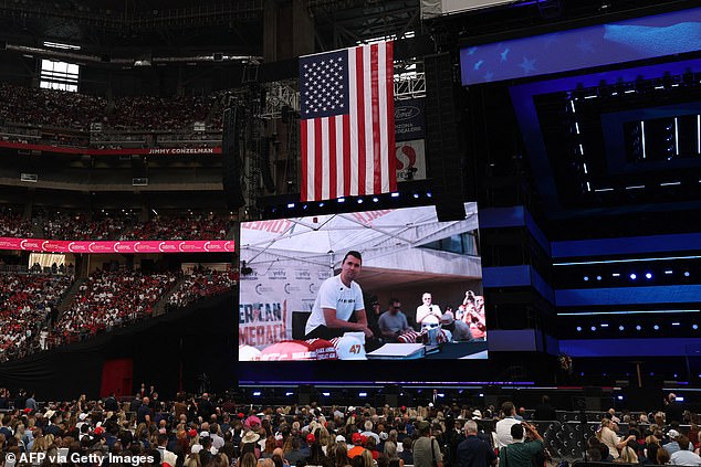 A video clip shows right-wing activist Charlie Kirk at a speaking event in Utah the day he was killed, during the public memorial service for Kirk at State Farm Stadium in Glendale, Arizona, on September 21, 2025. (Photo by Patrick T. Fallon / AFP) (Photo by PATRICK T. FALLON/AFP via Getty Images)