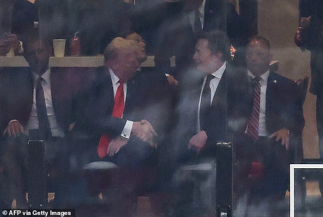 US President Donald Trump and Tesla CEO Elon Musk shake hands during the public memorial service for right-wing activist Charlie Kirk at State Farm Stadium in Glendale, Arizona, on September 21, 2025. (Photo by CHARLY TRIBALLEAU / AFP) (Photo by CHARLY TRIBALLEAU/AFP via Getty Images)